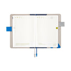 Hobonichi Techo A5 planner open showing May dates, grid pages, and blue wavy sea design