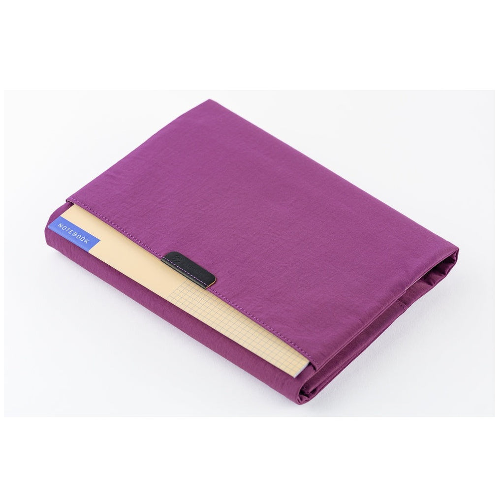Hobonichi Techo A5 purple planner cover with cream grid notebook in front pocket