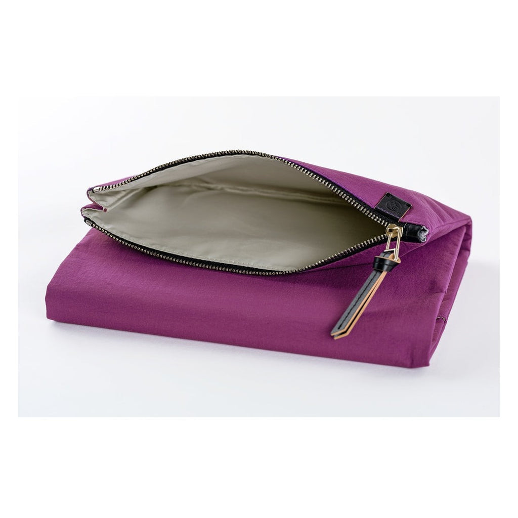 Partially unzipped Hobonichi Techo A5 purple planner cover revealing beige lining