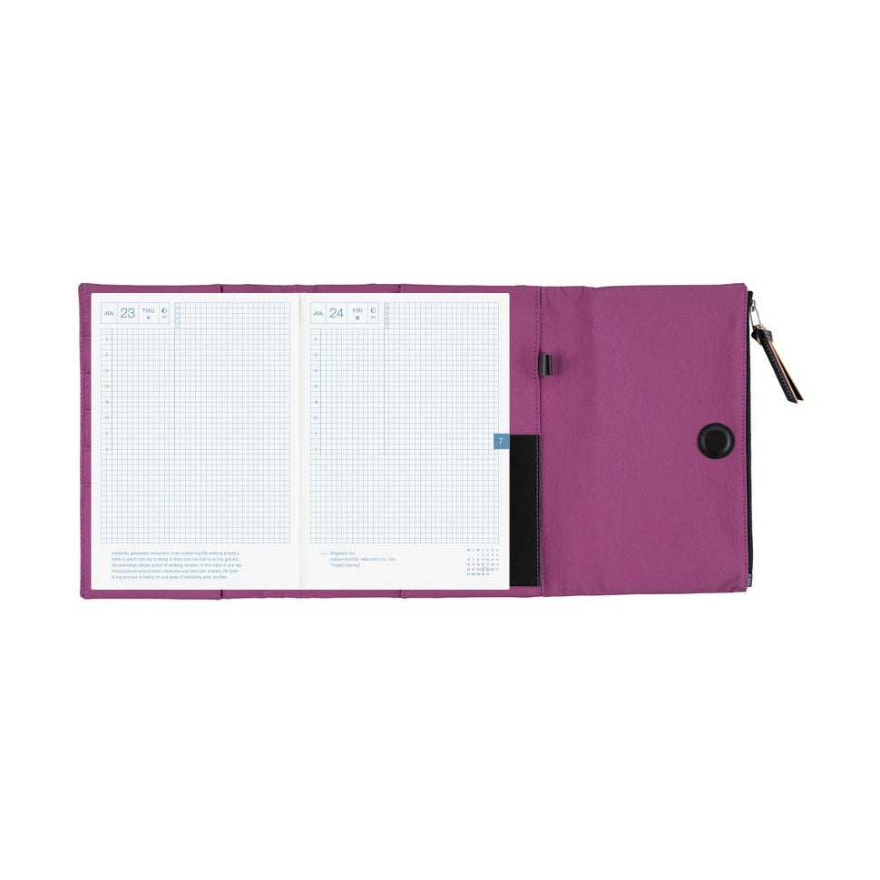 Open Hobonichi Techo A5 purple planner cover with dated notebook pages inside