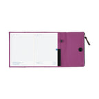 Open Hobonichi Techo A5 purple planner cover displaying grid pages and interior pockets