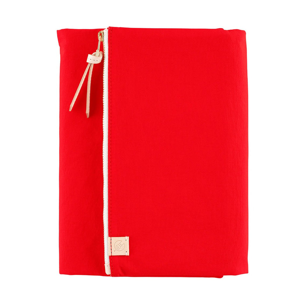 Full front view of upright red Hobonichi Techo A5 cover with white zipper and logo tag
