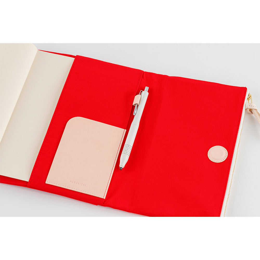 Hobonichi Techo A5 red tri-fold planner cover open showing beige interior and gusseted pocket