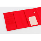 Close-up of red Hobonichi Techo A5 cover interior with embossed HOBONICHI card pocket