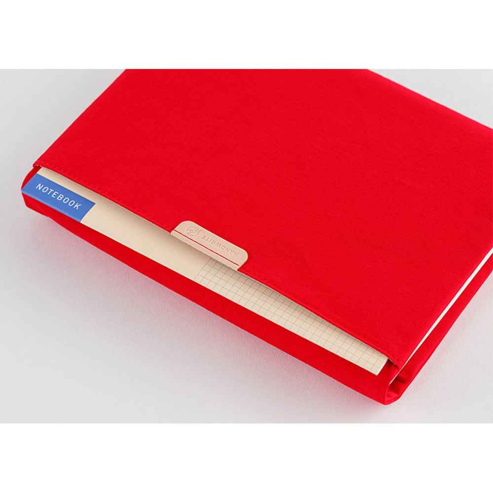 Red Hobonichi Techo A5 Tragen cover with notebook inserted in front gusseted pocket