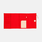 Flat lay of open red Hobonichi Techo A5 cover displaying four horizontal pockets and card slot