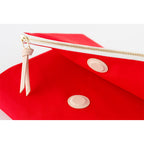 Angled close-up of red Hobonichi Techo A5 cover showing gusseted profile and leather patches