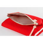 Open red Hobonichi Techo A5 cover displaying light beige interior lining and zipper detail