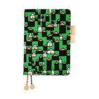 Hobonichi Techo A5 planner cover with green forest house pattern and beaded tassels