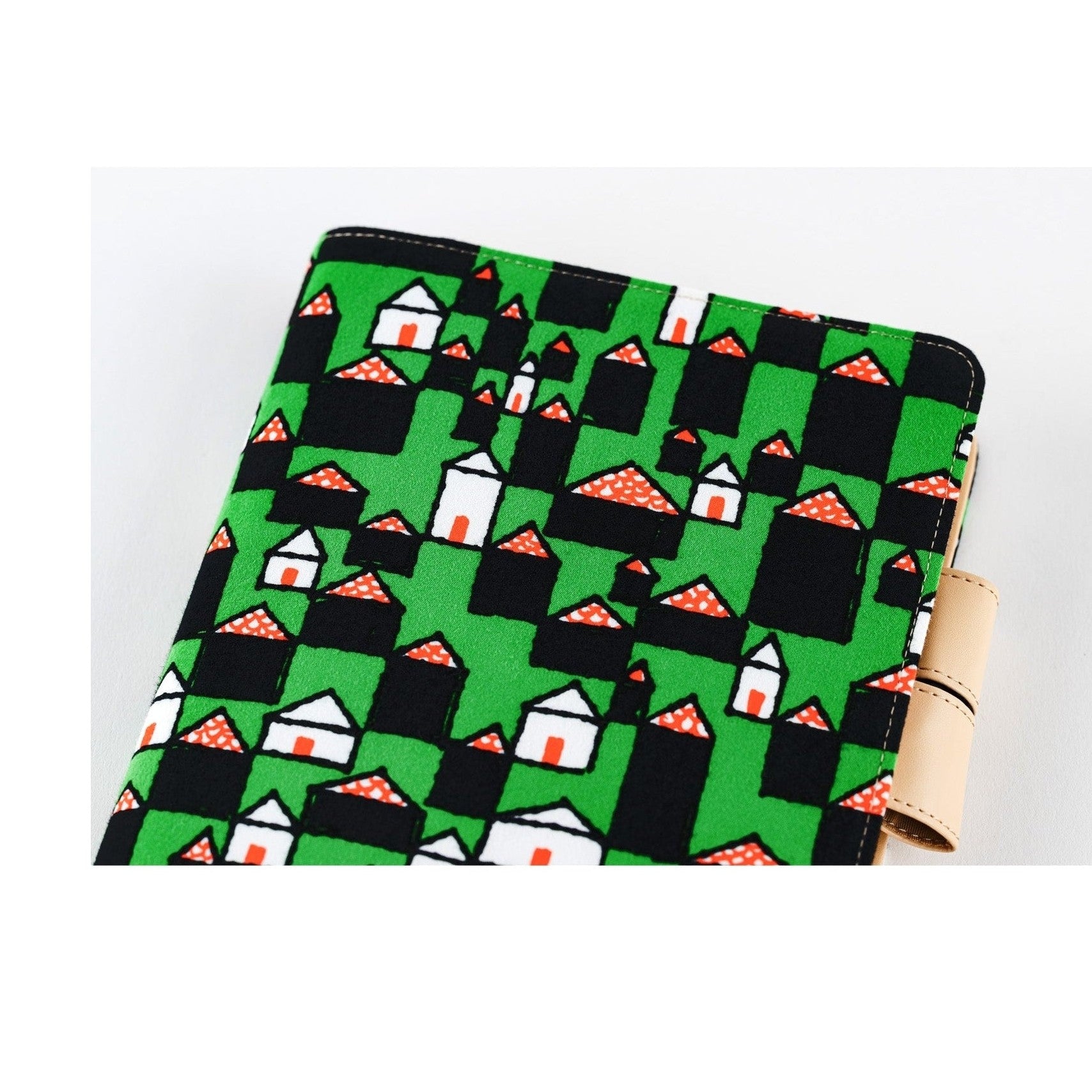 Green Hobonichi Techo A5 cover with stylized houses and red polka dot roof accents
