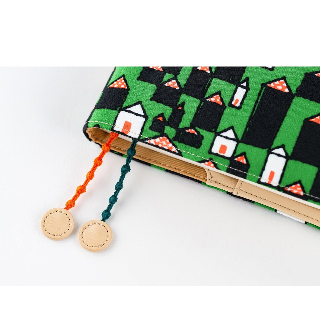 Close-up of Hobonichi Techo A5 cover showing woven texture and orange teal tassel detail