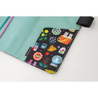 Mint green interior Hobonichi A5 cover with patterned pockets and teal pink ribbons by Yumi Kitagishi