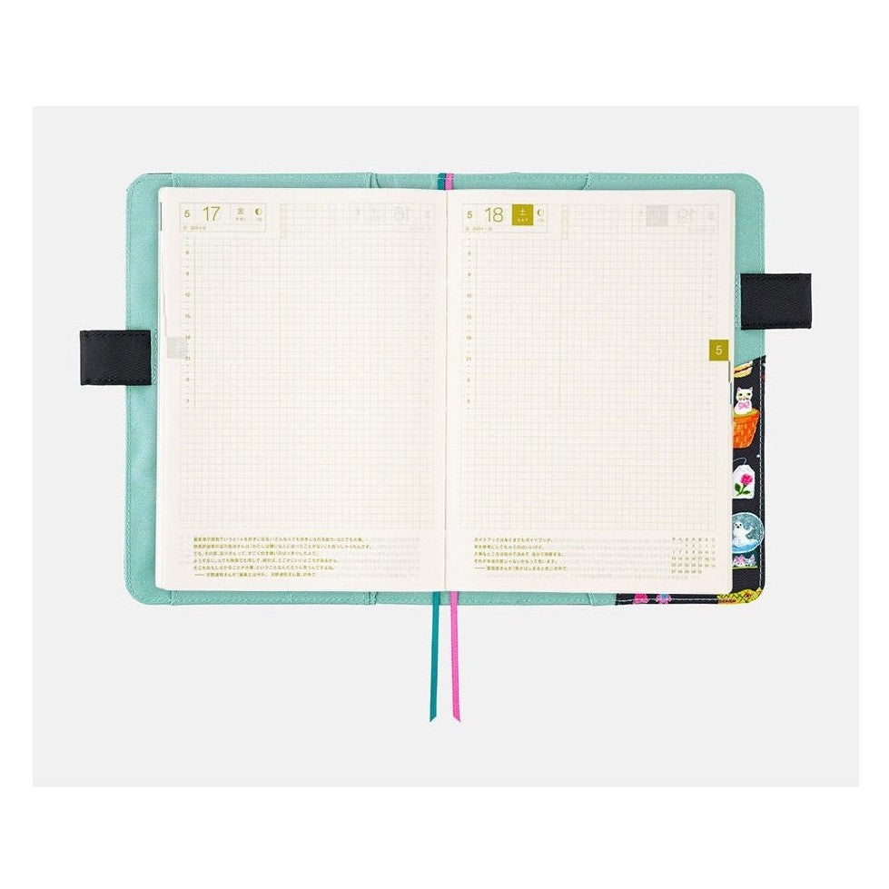 Hobonichi A5 planner pages inside Yumi Kitagishi Little Gifts cover with grid layout and gold tabs