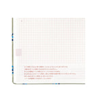 Hobonichi Techo A5 2025 diary page with red dotted grid squares, pink Japanese text, and small blue snake illustration