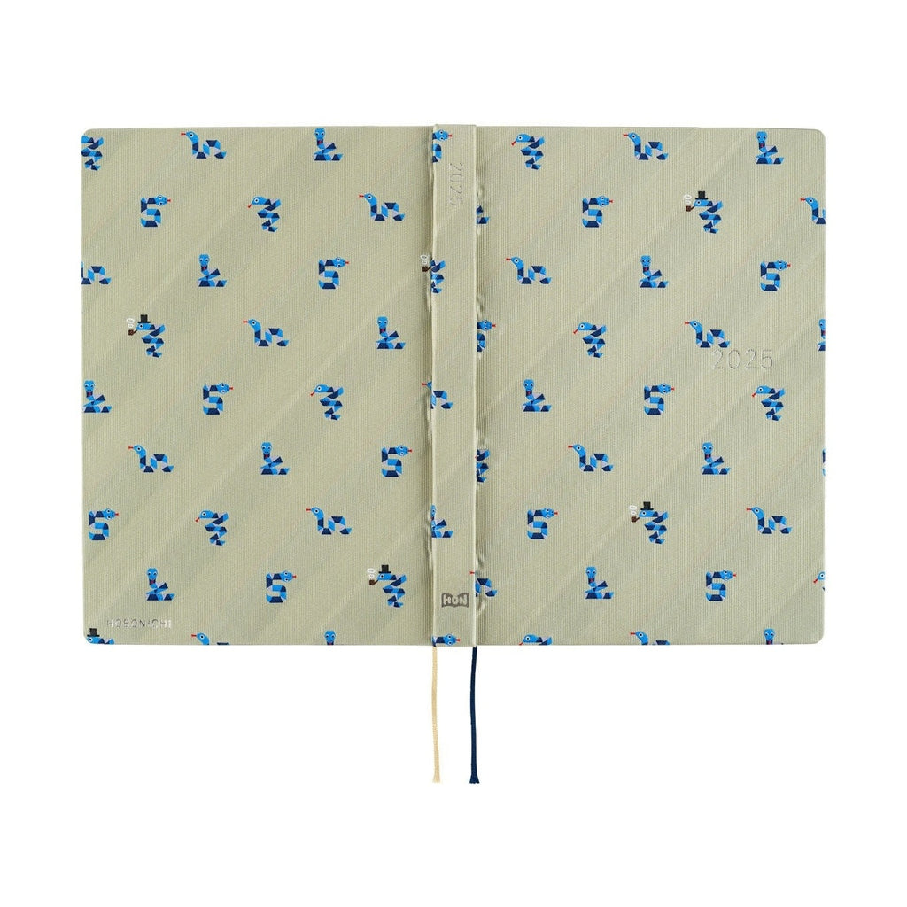 Hobonichi Techo A5 2025 Snake Toy diary open showing beige woven cover with blue snake pattern and pipe-wearing snake detail