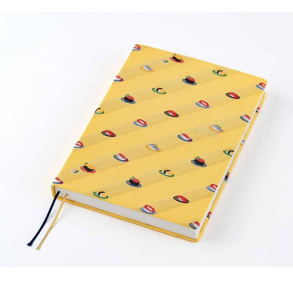 Angled shot of open Hobonichi Techo A5 showing white pages and sushi spine