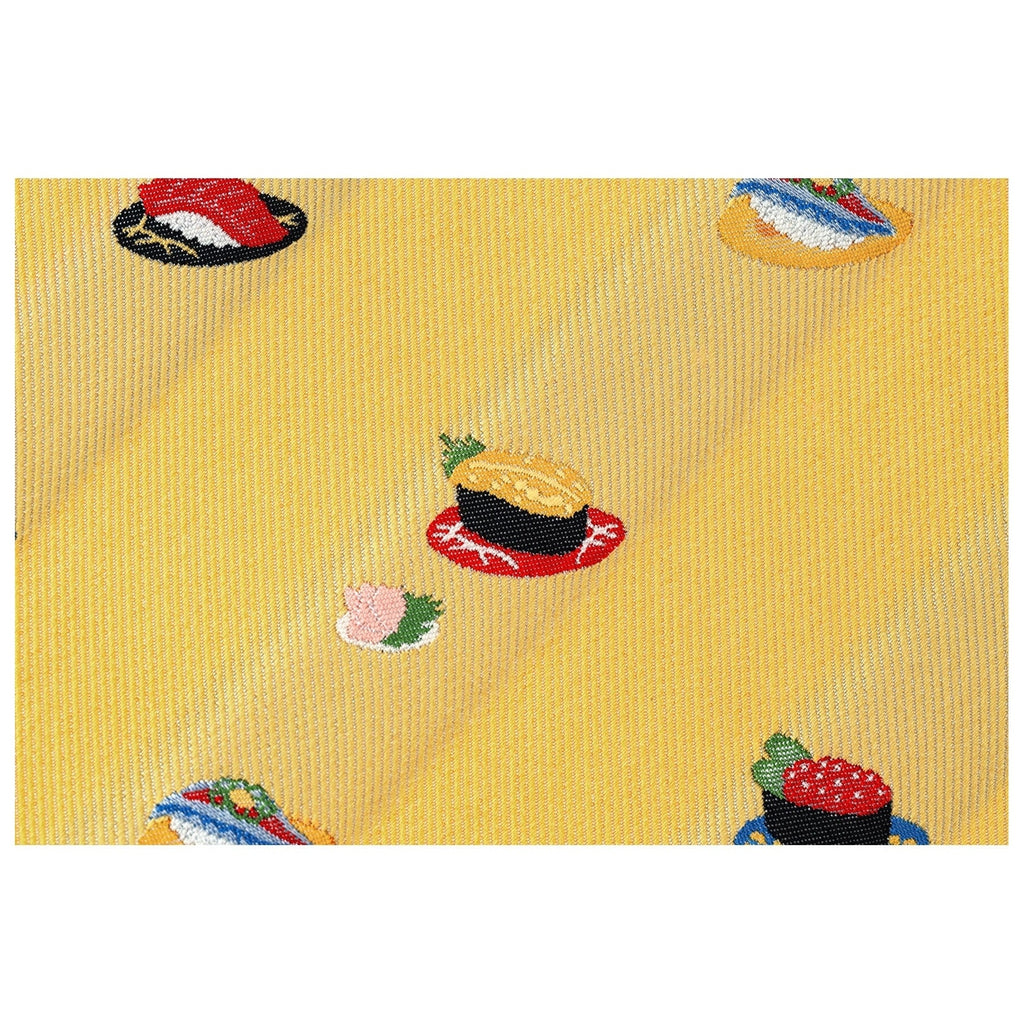 Detailed embroidery of sushi pieces on textured yellow Hobonichi Techo cover