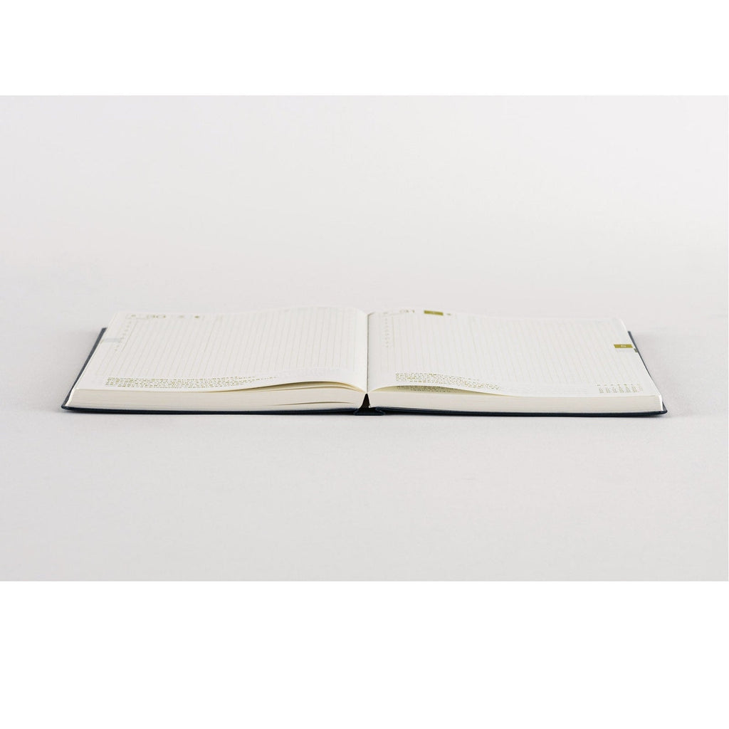 Blank cream grid pages in Hobonichi Techo with navy spine and gold tabs