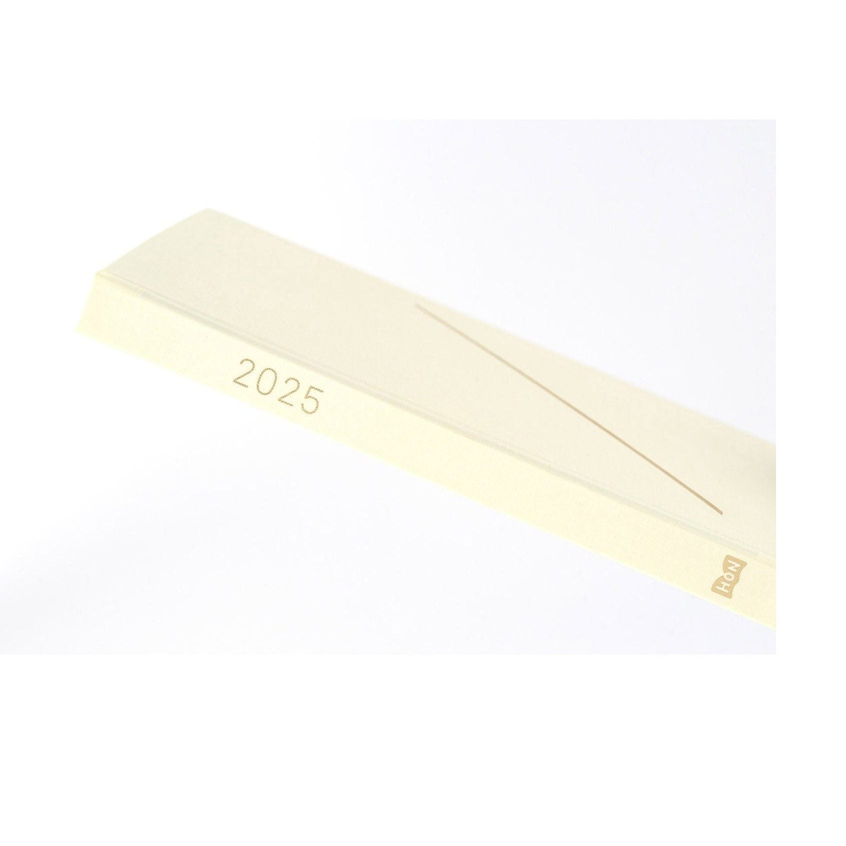 Hobonichi Techo A5 spine detail showing 2025 year and HON logo in gold foil