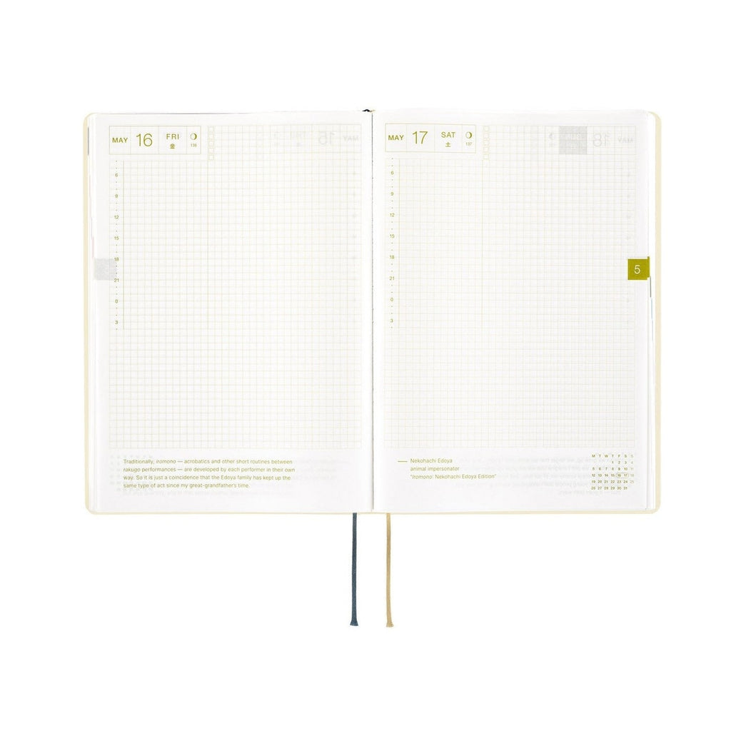 Hobonichi Techo A5 May daily spread with gold foil quote and yellow tab marker