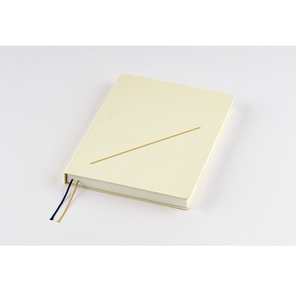 Hobonichi Techo A5 closed diary with matte cream cover and single gold slash line