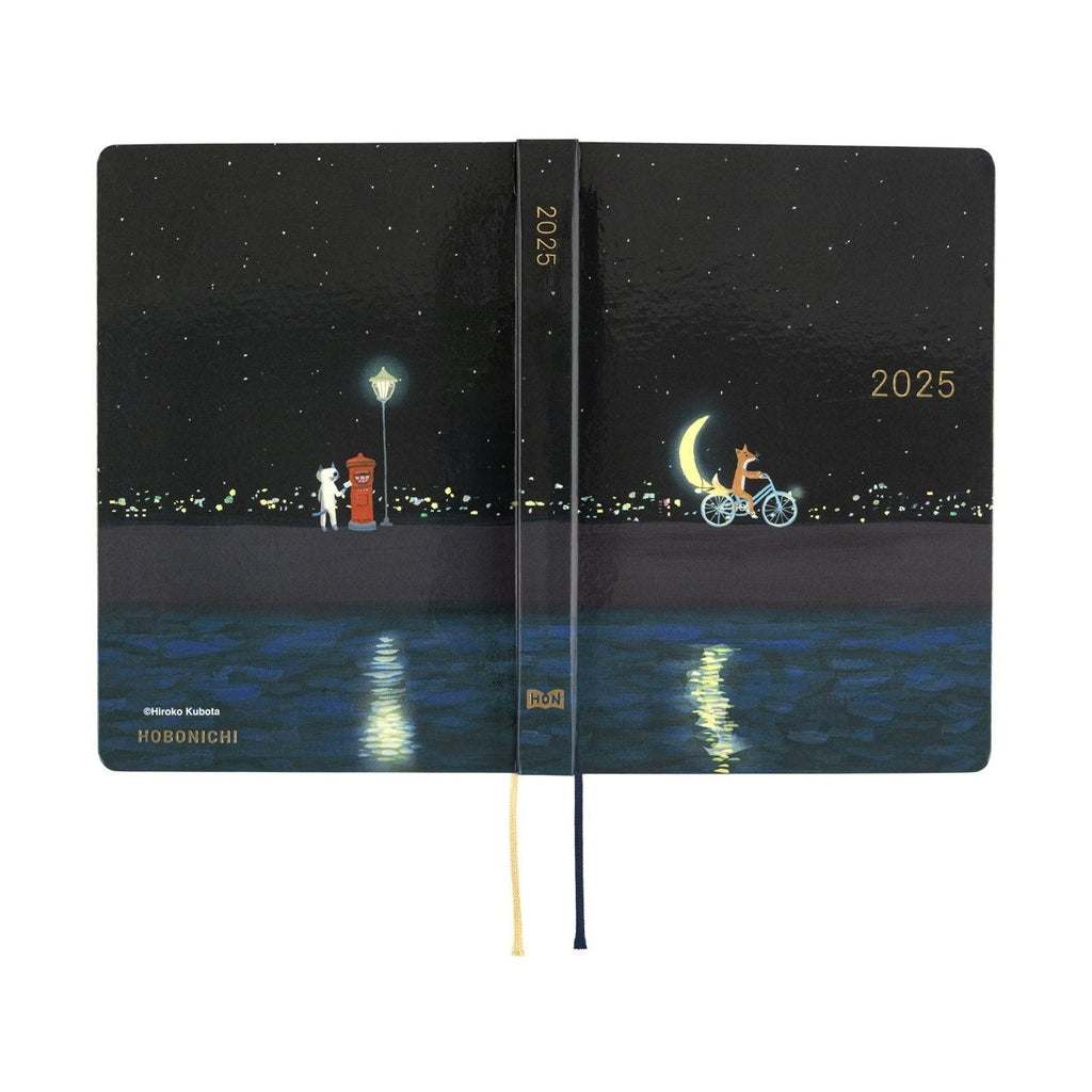 Hobonichi Techo A6 2025 closed diary displaying full fox and cat artwork with gold spine text