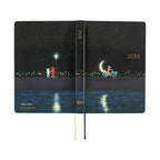 Hobonichi Techo A6 2025 closed diary displaying full fox and cat artwork with gold spine text
