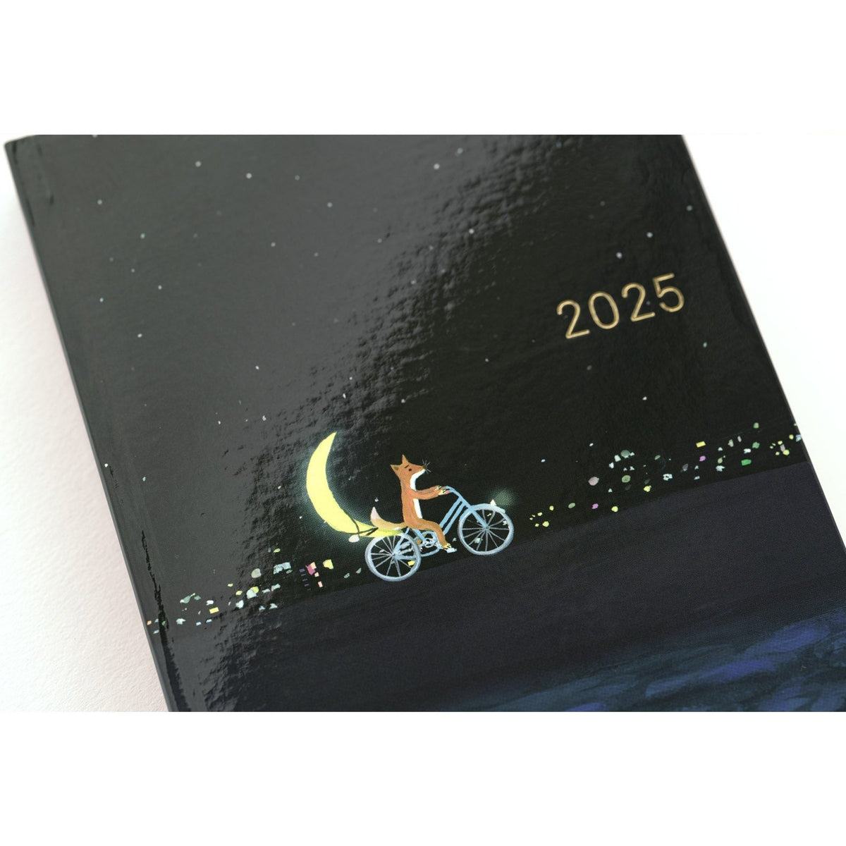 Hobonichi Techo A6 2025 hardcover with matte black finish and gold foil fox illustration