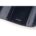 Interior left panel of navy leather cover with gold embossed Hobonichi logo and stitching
