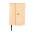 Front view of closed A6 One Piece Thousand Sunny notebook cover with textured beige material