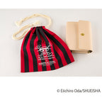 Hobonichi Techo A6 One Piece logbook cover displayed with matching pirate skull drawstring bag