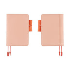 Two side-by-side light pink Hobonichi Techo A6 covers with orange accents on white background