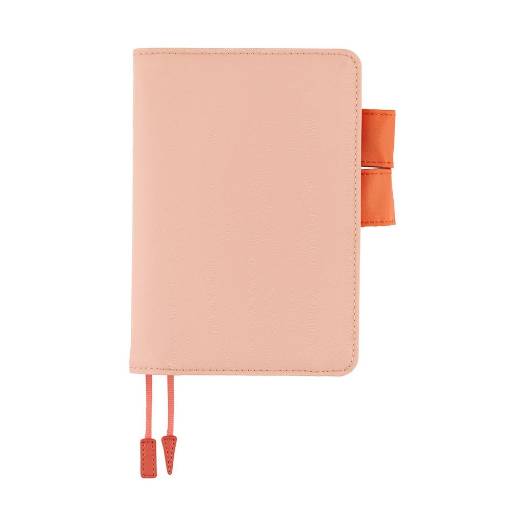 Closed light pink Hobonichi Techo A6 cover with orange strap clasp and ribbon bookmark