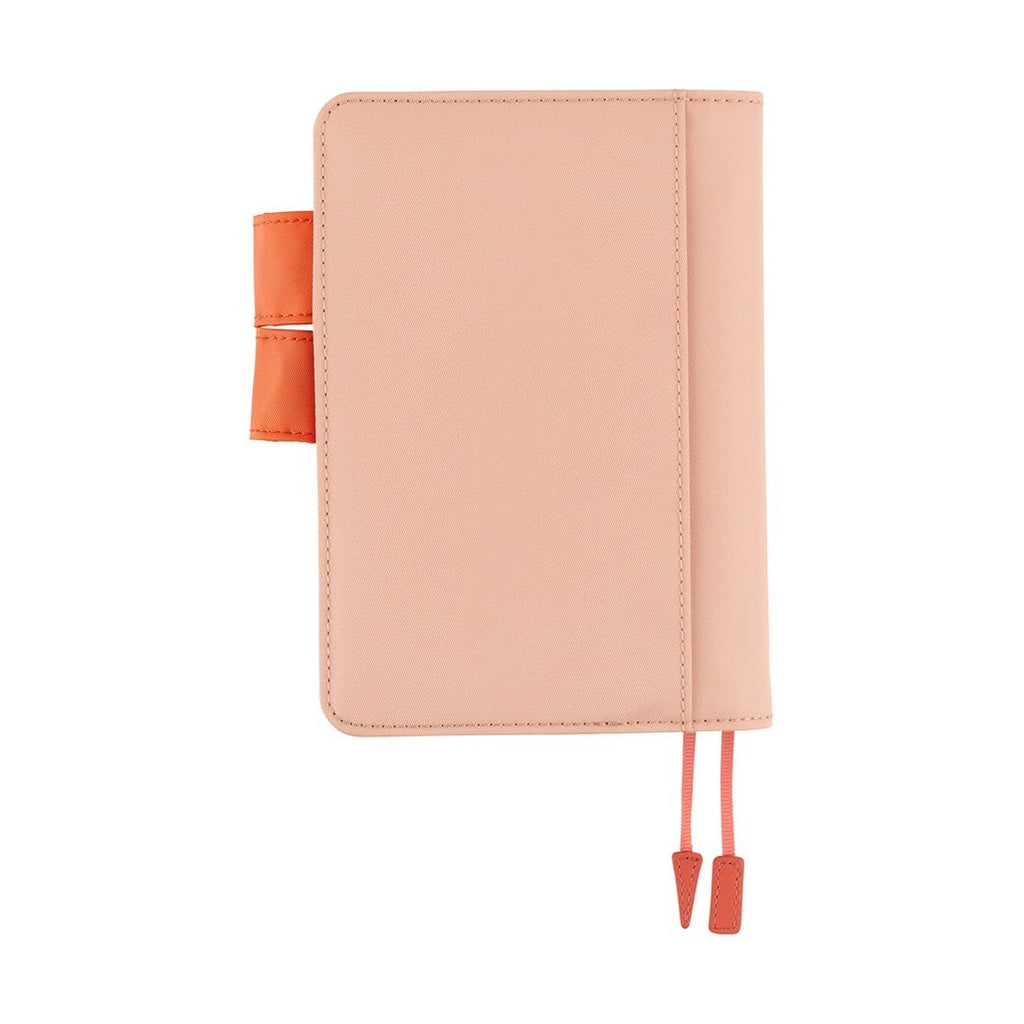 Back view of textured pink Hobonichi A6 planner cover with stitched edges and orange clasp