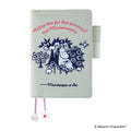 Front of pale mint Moominmamma embroidered cover with pink quote and shell charms