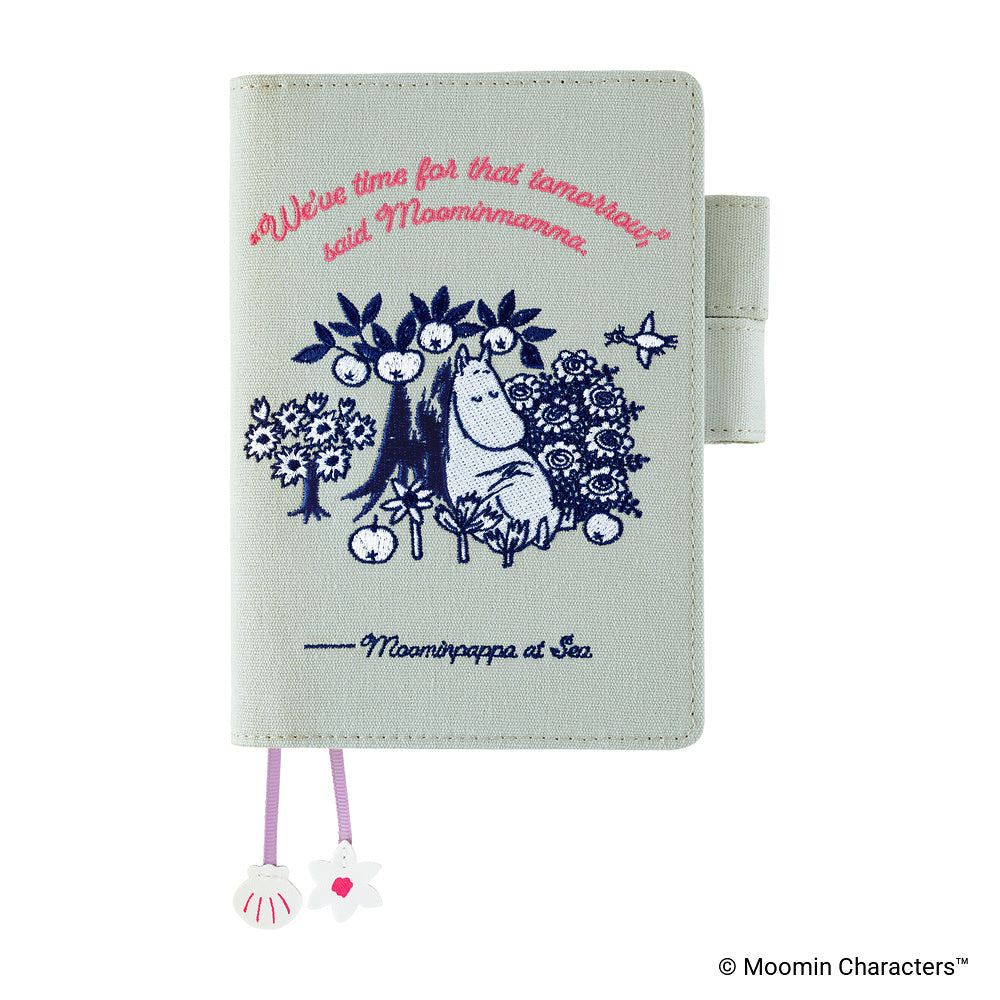 Front of pale mint Moominmamma embroidered cover with pink quote and shell charms
