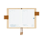 Hobonichi A6 planner interior with Japanese daily layout and attached pen holder strap