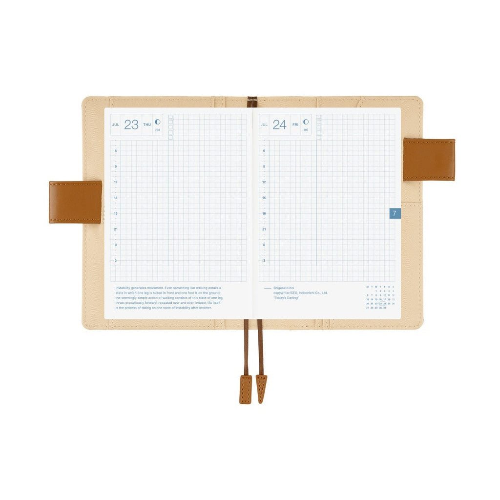 Hobonichi A6 planner open to July grid daily pages with time slots and date boxes