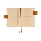 Interior of Hobonichi A6 planner cover showing beige fabric lining and multiple pockets