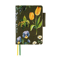 Closed Hobonichi Techo A6 planner cover with painterly floral design and woven strap