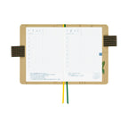 Open Hobonichi planner showing July 1-2 pages with Japanese text and plant-themed pocket