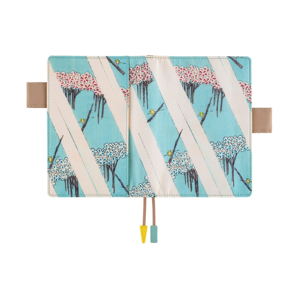 Closed Hobonichi A6 planner cover with blue stripes, cherry blossoms, and birds