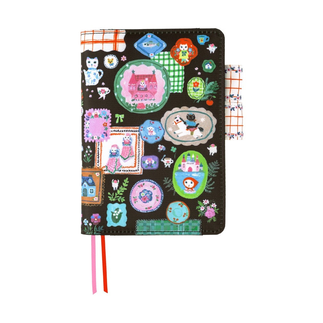 Hobonichi Techo A6 planner cover with Yumi Kitagishi white cat table decor on dark brown polyester