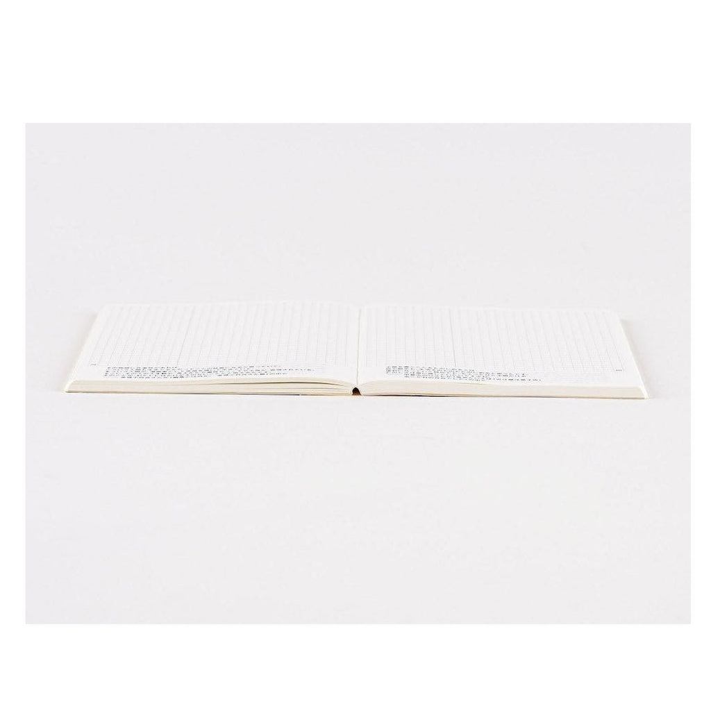 Flat-lay of Hobonichi Techo 2024 A6 notebook with blank grid page and center spine fold