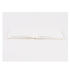 Flat-lay of Hobonichi Techo 2024 A6 notebook with blank grid page and center spine fold