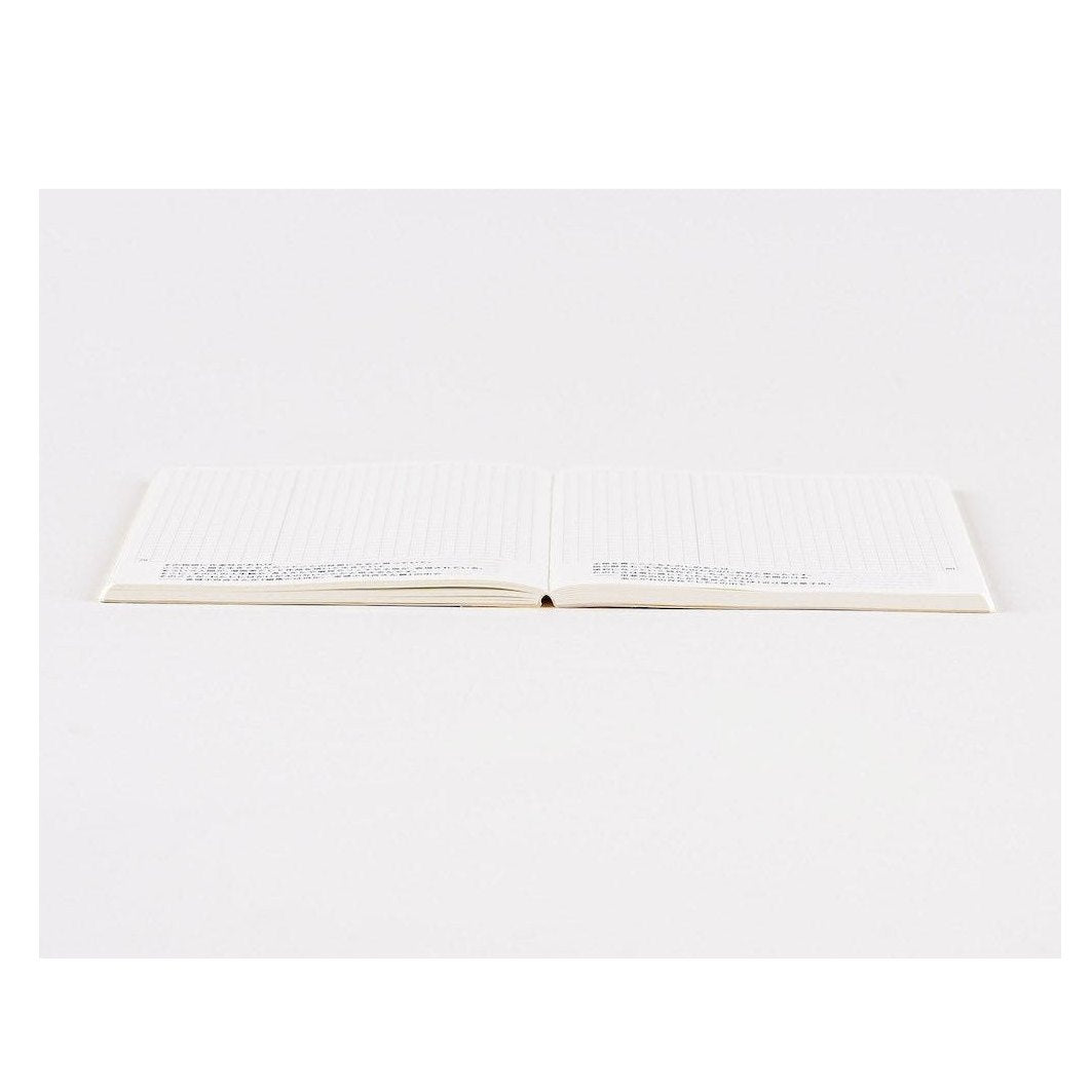 Flat-lay of Hobonichi Techo 2024 A6 notebook with blank grid page and center spine fold