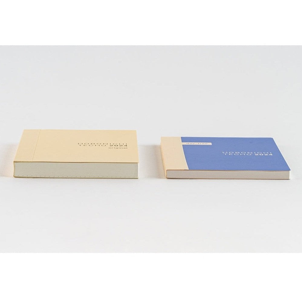 Horizontal view of Hobonichi Techo 2024 A6 original and day-free covers with thick paper stacks