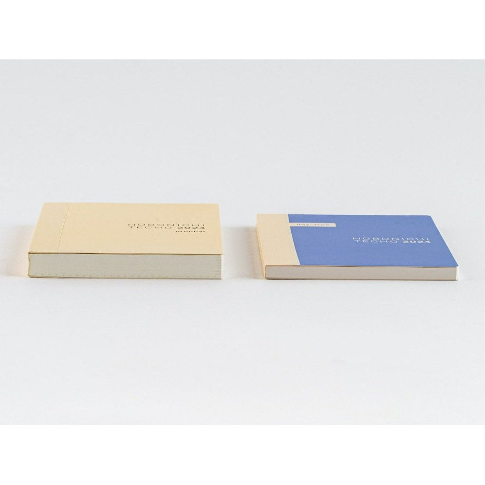 Beige and blue Hobonichi Techo 2024 A6 diaries side by side showing stitched binding edges