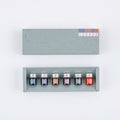 Sage-green packaging box containing six glass bottles of color-matched Hobonichi Techo inks for months 7-12