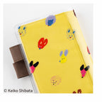 Yellow A6 Hobonichi Techo cover with Keiko Shibata dog ears fluttering PVC sleeve